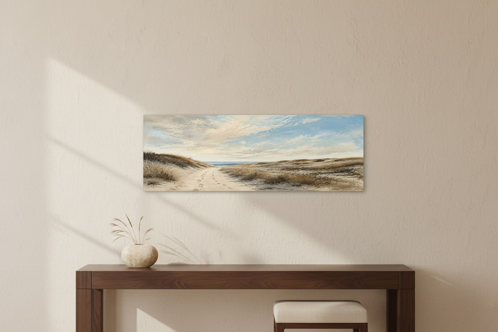 Way Home Through the Dunes unframed wide 3:1 coastal panorama canvas above a walnut console in a warm cream entryway — room styling mockup.